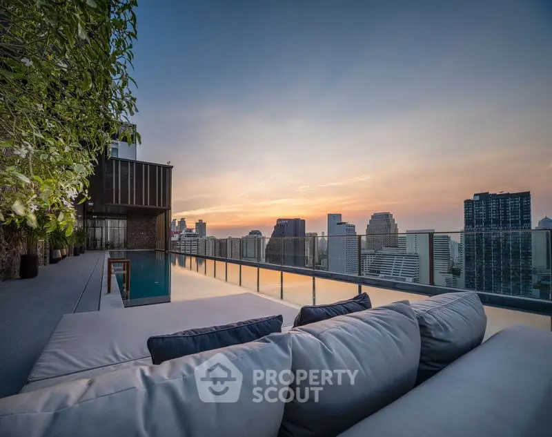 Luxurious rooftop with stunning city skyline view and infinity pool at sunset.