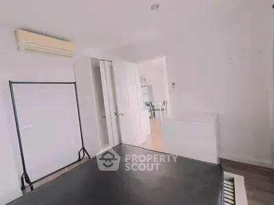 Spacious bedroom with modern air conditioning and ample storage in a stylish apartment.