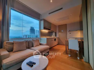 Modern living room with stunning city view and sleek kitchen design.