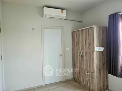 Minimalist bedroom with air conditioning and wooden wardrobe