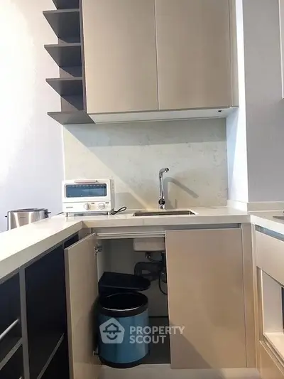 Modern kitchen with sleek cabinetry and compact appliances, featuring a stylish open layout.