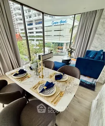 Luxurious dining area with elegant table setting and stunning city view.