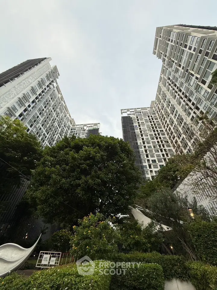 Stunning modern high-rise buildings with lush greenery and unique architectural design.