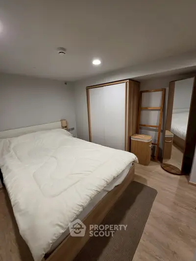 Cozy bedroom with modern furniture and ample storage space, perfect for a restful retreat.