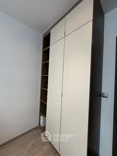 Modern built-in wardrobe with sleek design and ample storage space in a contemporary home.