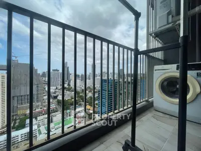 High-rise balcony with cityscape view and washing machine, perfect urban living.