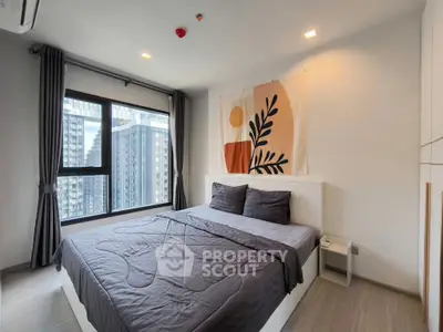 Modern bedroom with large window and stylish decor in urban apartment