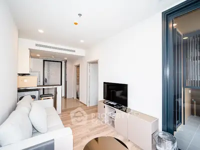 Modern living room with sleek furniture and open kitchen layout