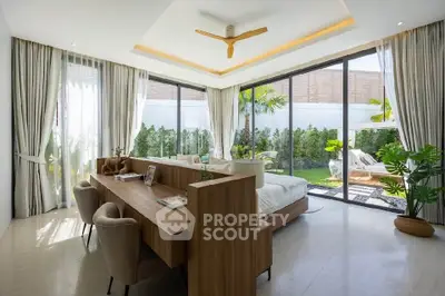 Luxurious bedroom with garden view, featuring elegant decor and floor-to-ceiling windows.