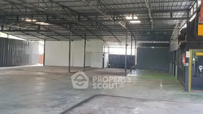 Spacious industrial warehouse with high ceilings and open floor plan, ideal for storage or manufacturing.
