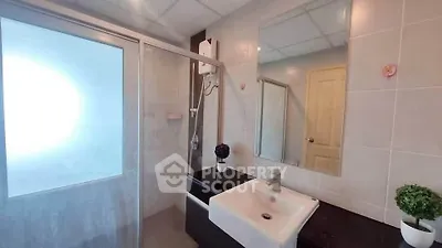 Modern bathroom with sleek fixtures and glass shower enclosure