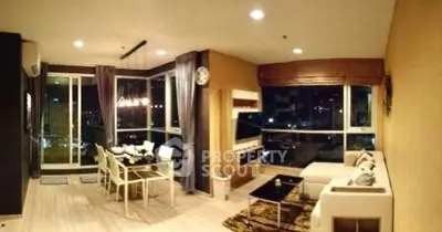 Modern living room with large windows and city view, featuring stylish furniture and elegant lighting.