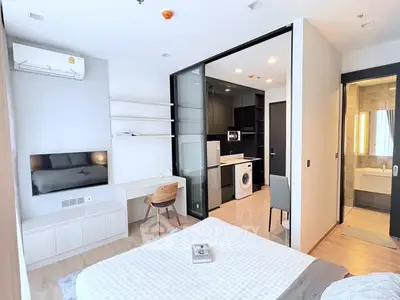 Modern studio apartment with open layout, featuring a cozy bedroom, sleek kitchen, and stylish bathroom.