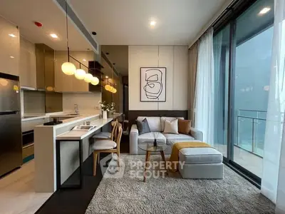 Modern open-layout living room with stylish kitchen and balcony view