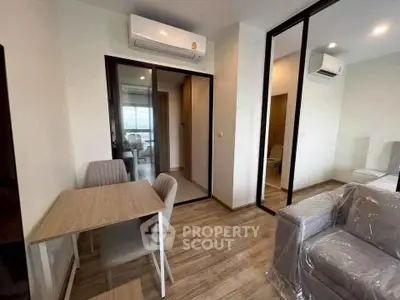 Modern apartment interior with air conditioning, dining area, and glass partitions for a sleek, contemporary look.
