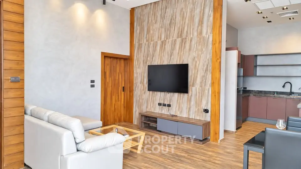 Modern living room with sleek design and open kitchen layout