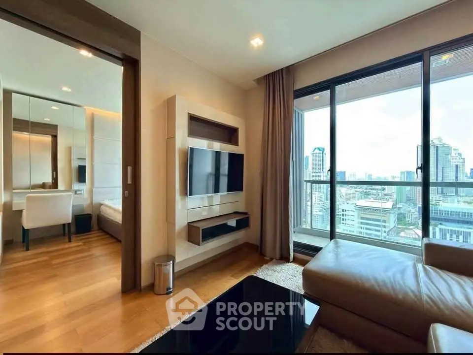 Luxurious living room with stunning city view and modern decor in high-rise apartment.
