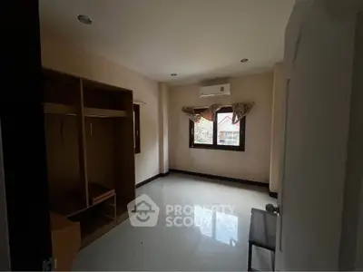 Spacious bedroom with built-in wardrobe and natural light