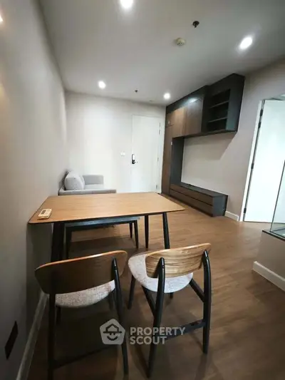 Modern living room with wooden flooring and minimalist furniture in a cozy apartment.