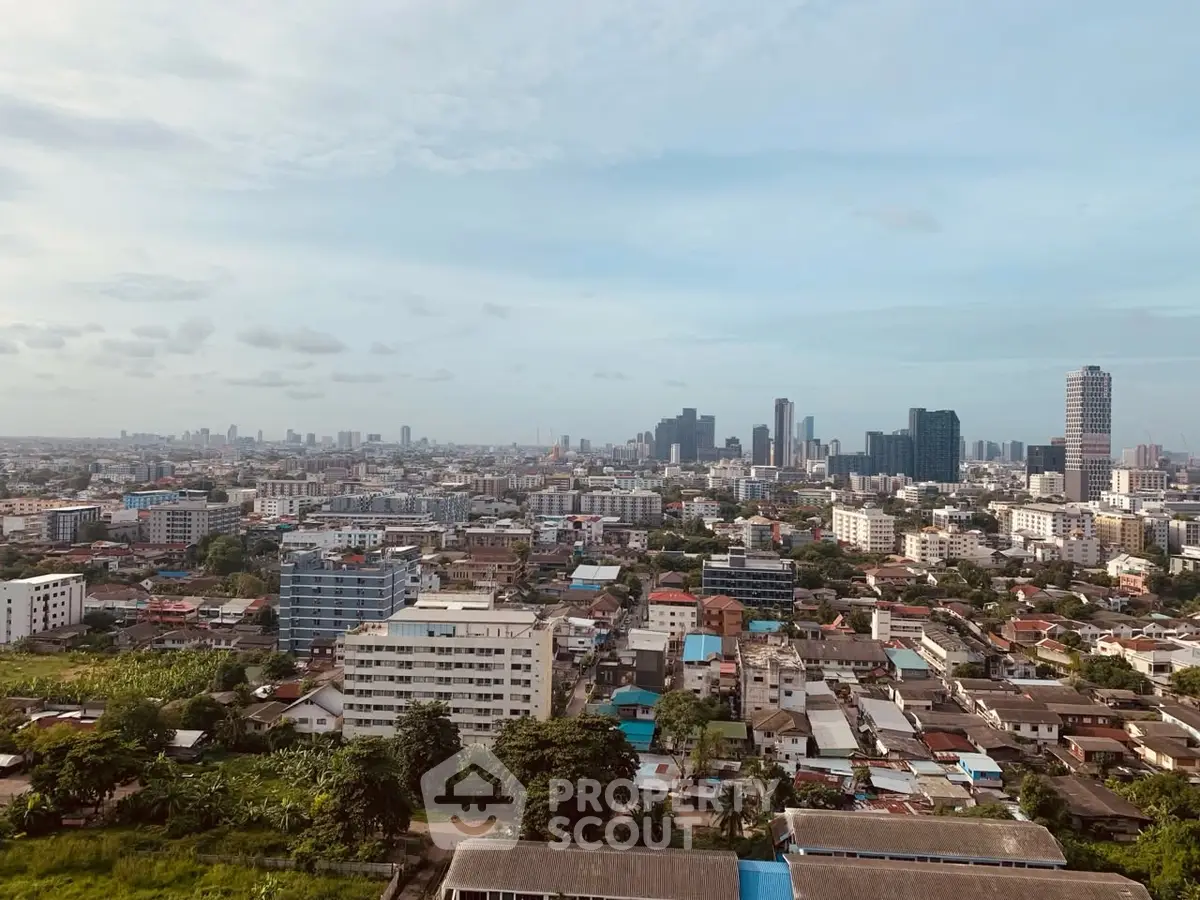 Stunning cityscape view showcasing urban skyline and residential buildings under a clear blue sky.