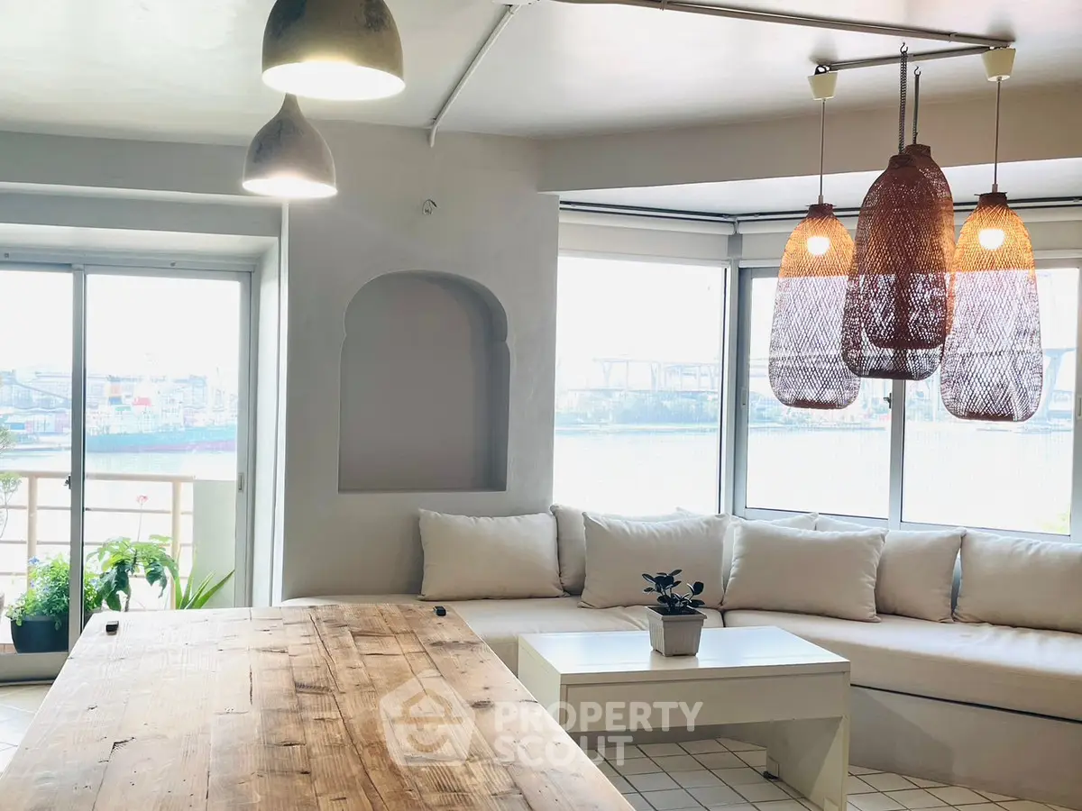 Bright and airy living room with modern decor and large windows offering a stunning view.