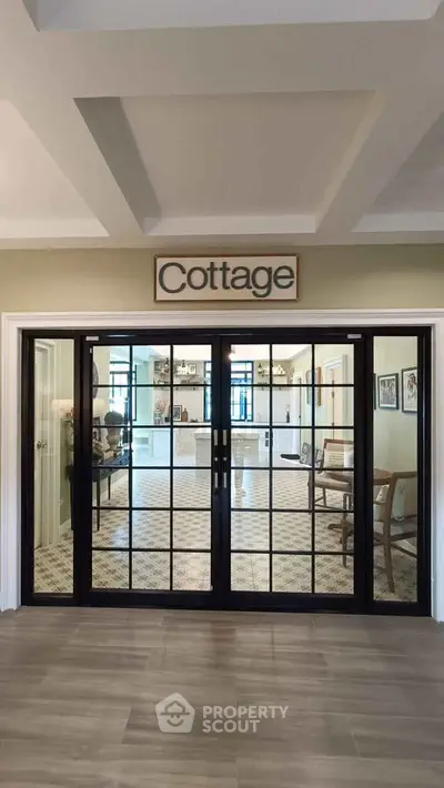 Charming cottage-style interior with elegant glass doors and cozy decor