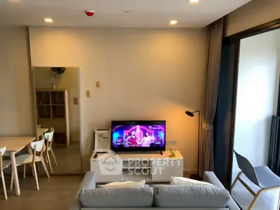 Modern living room with stylish decor and balcony access, perfect for relaxation and entertainment.