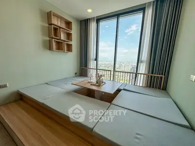 Modern minimalist living room with panoramic city view and cozy seating area.