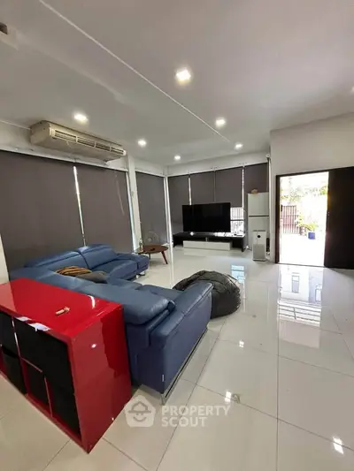 Spacious modern living room with sleek furniture and large windows