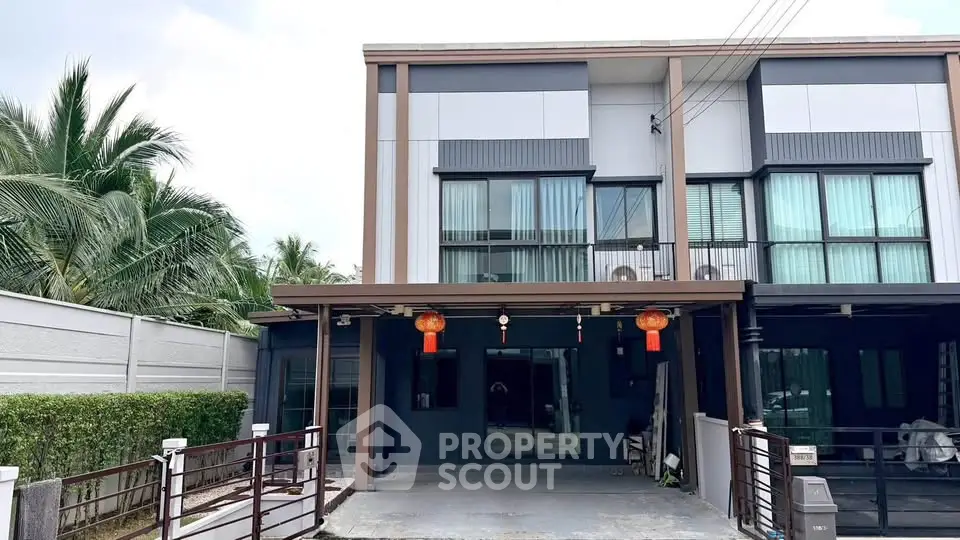 Modern townhouse exterior with spacious driveway and contemporary design.