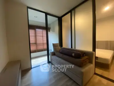 Modern bedroom with glass partition and cozy sofa bed