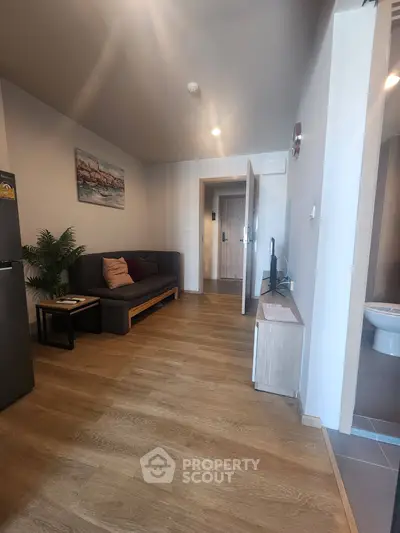 Modern living room with wooden flooring and stylish decor in a cozy apartment.
