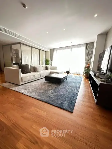 Spacious modern living room with elegant decor and large windows