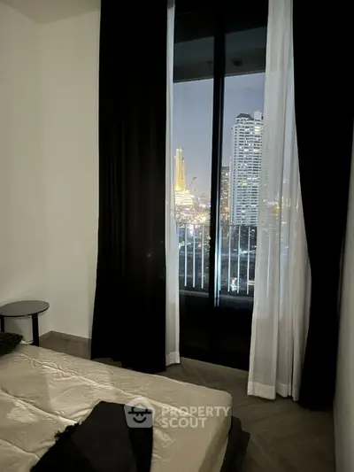 Luxurious bedroom with stunning city view from large window, featuring elegant curtains and modern decor.