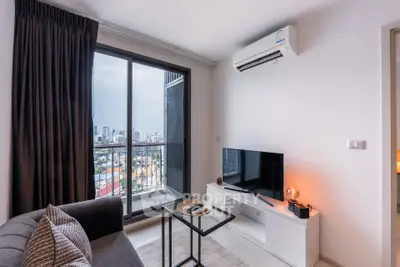 Modern living room with city view, sleek furniture, and natural light.