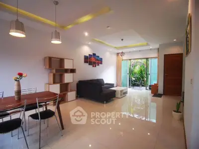 Spacious modern living room with elegant dining area and garden view.