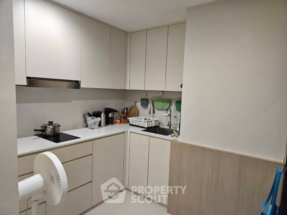 Modern kitchen with sleek cabinetry and built-in appliances in a compact layout.
