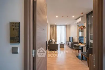 Modern living room with open layout and stylish decor, featuring a cozy seating area and natural light.