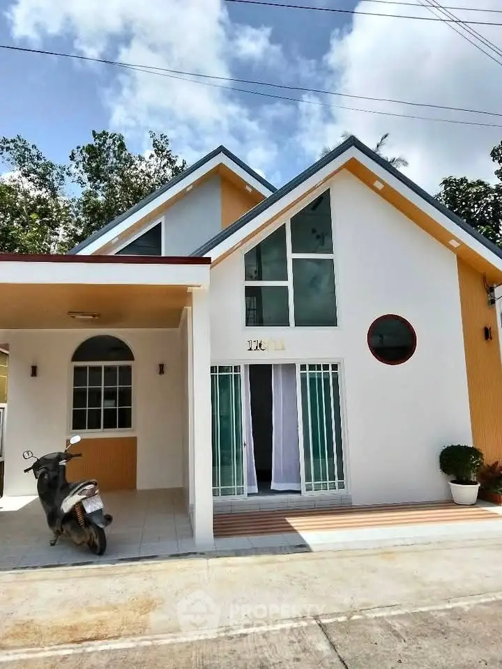 Charming modern house with unique architecture and spacious driveway, perfect for family living.