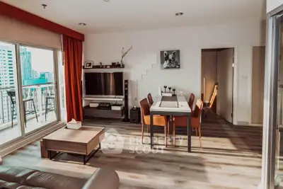 Spacious living room with modern decor and balcony view in urban apartment
