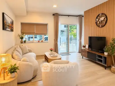 Modern living room with cozy furniture and large window opening to a balcony, featuring stylish decor.