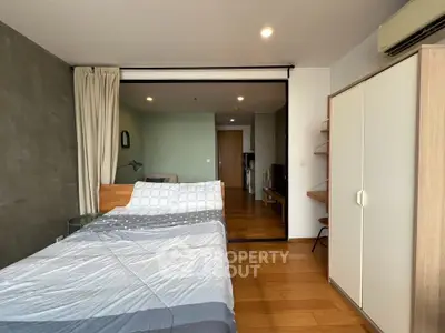 Modern bedroom with wooden flooring and stylish decor