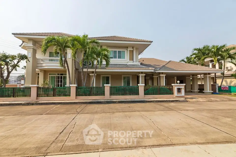 Stunning two-story house with lush palm trees and spacious driveway in a serene neighborhood.