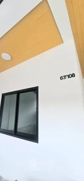 Modern building exterior with stylish window and unique architectural design.