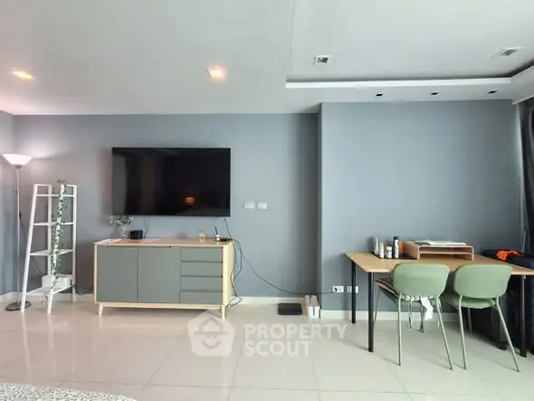 Modern living room with sleek TV setup and stylish workspace