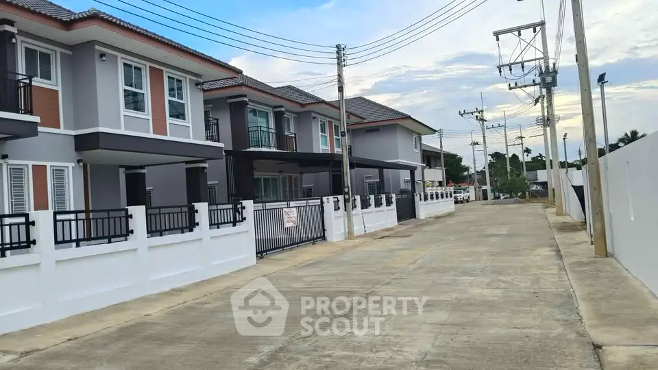 Modern townhouse exterior with gated entrance and spacious driveway