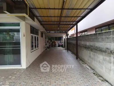 Spacious covered outdoor area with tiled flooring and ample natural light, perfect for versatile use.