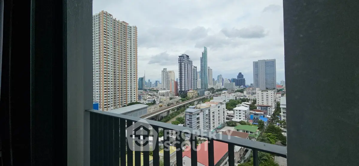 Stunning cityscape view from a high-rise balcony overlooking urban skyline and skyscrapers.