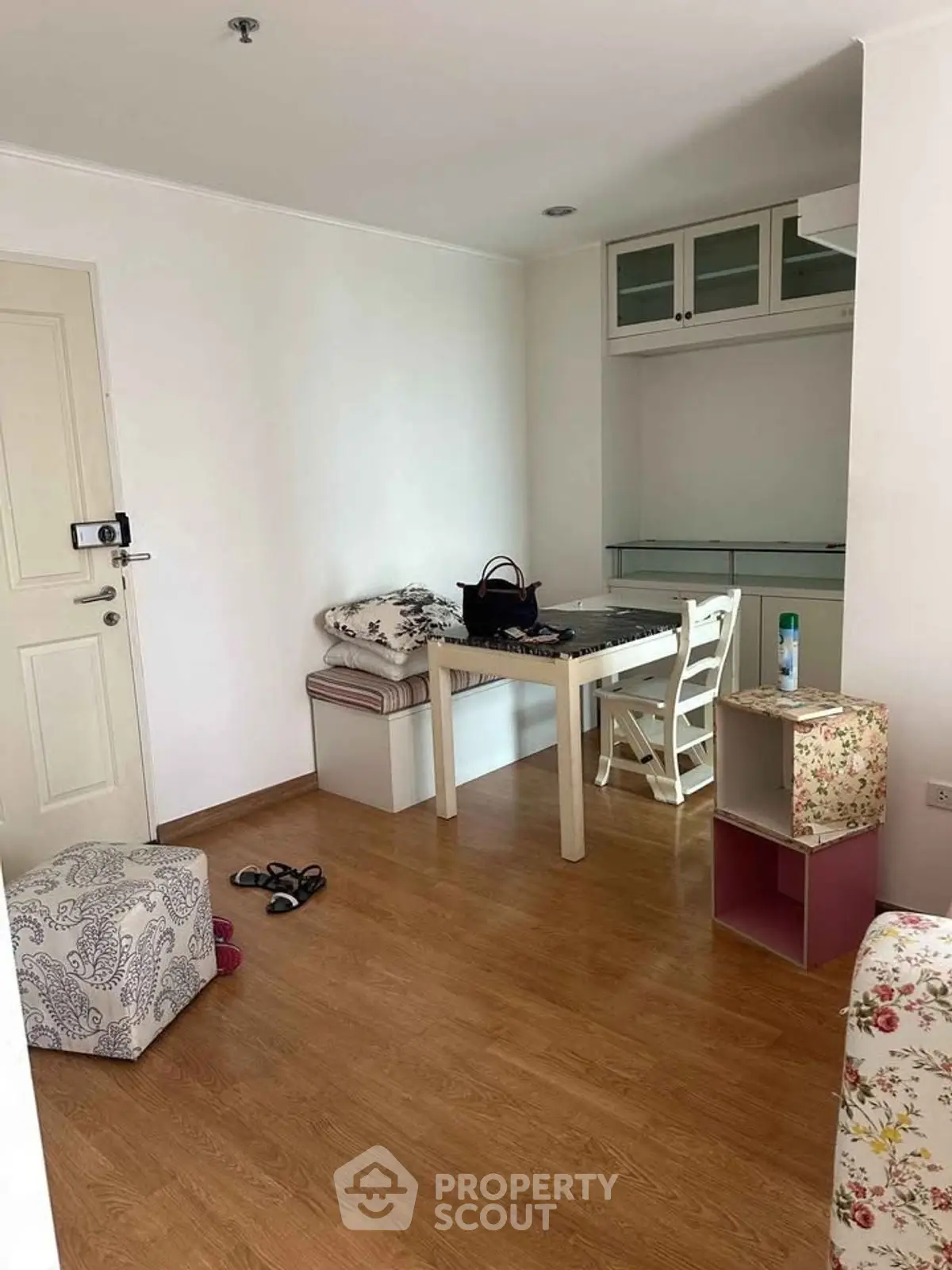 Cozy interior with wooden flooring and compact dining area in modern apartment