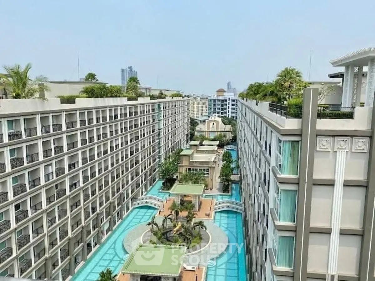 Luxurious residential complex with stunning pool and garden views in urban setting.